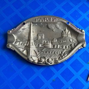 raised relief Paris souvenir 6” x 4” has the names on the back wall placket
